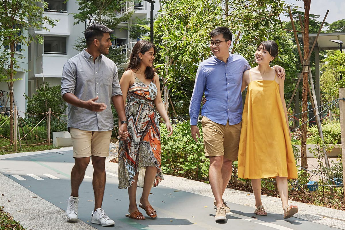 Two couples walking through the common area of an HDB estate.